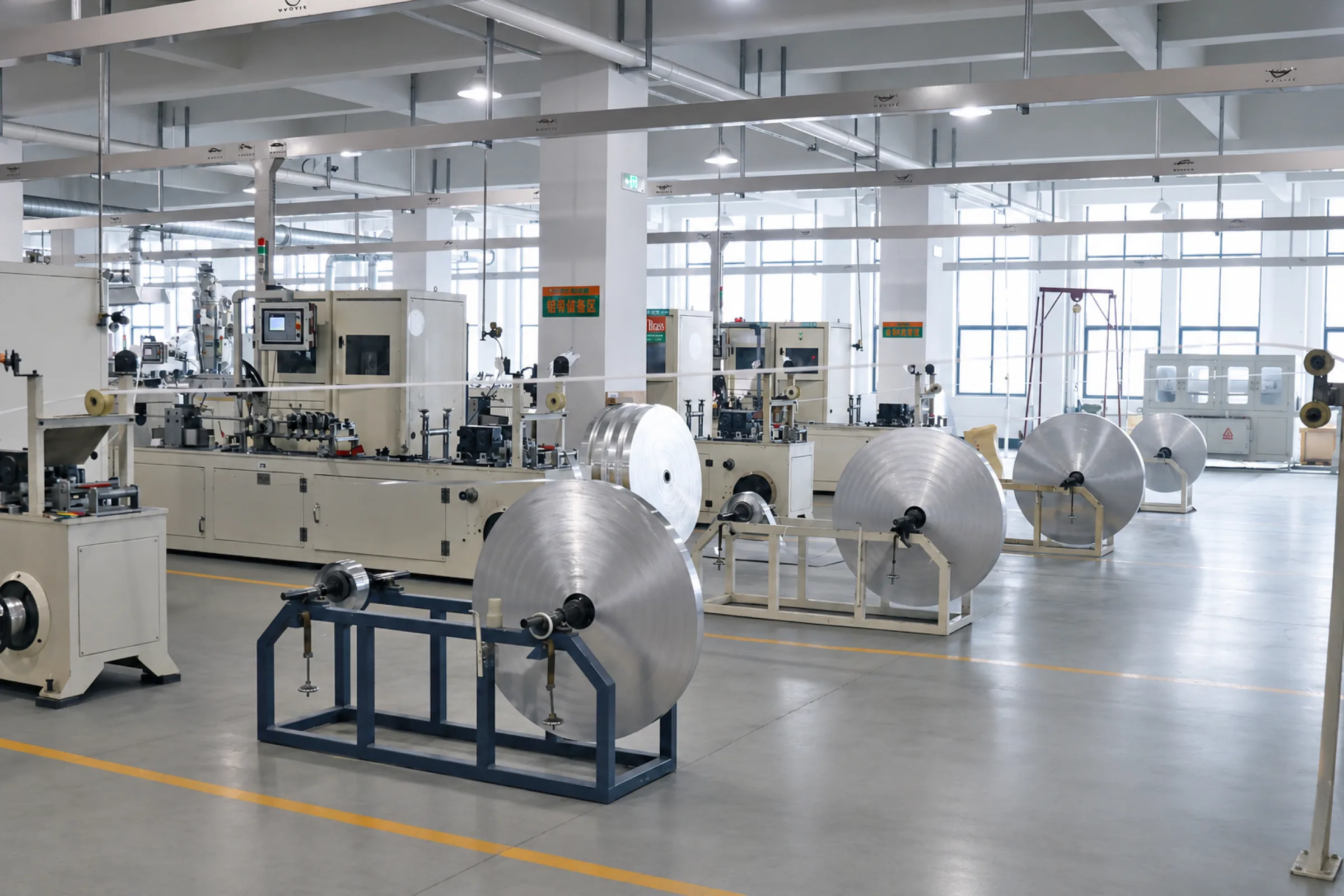 Row of PEX pipe coiling machines on the IFANNova factory floor